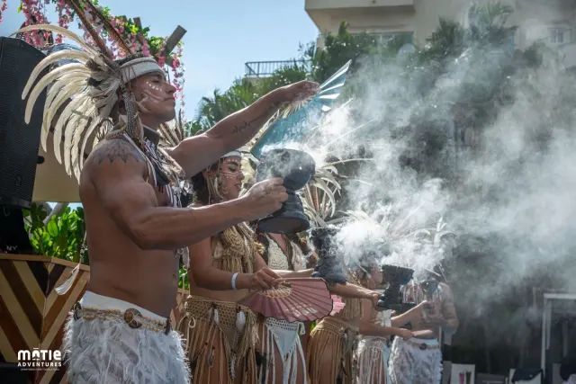 Ceremony with feather dancers and copal at the edge of the beach
