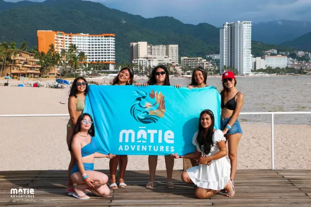 MATIE class posing with the flag on the Puerto Vallarta boardwalk